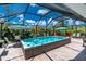 The backyard has an in-ground pool, lounge chairs, and tropical landscaping at 185 Hercules Dr, Rotonda West, FL 33947