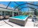A backyard swim spa under a screened enclosure provides outdoor enjoyment and comfort at 185 Hercules Dr, Rotonda West, FL 33947