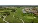 Beautiful aerial view of a sprawling golf course community with water features and lush green landscaping at 1865 Rival Ter, North Port, FL 34286