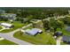 Captivating aerial shot showcasing a well-kept lawn, surrounding trees, and peaceful neighborhood ambiance at 1865 Rival Ter, North Port, FL 34286