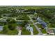 An aerial view of a home located in a quiet neighborhood with trees and lake at 1865 Rival Ter, North Port, FL 34286