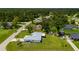 A high-angle view highlights a home with a well-maintained yard in a serene, tree-filled neighborhood at 1865 Rival Ter, North Port, FL 34286
