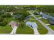 An aerial view showing the house with nice landscaping in a serene neighborhood near lake at 1865 Rival Ter, North Port, FL 34286