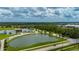 Scenic aerial shot featuring a modern building, a picturesque pond with a fountain, and beautiful landscaping at 1865 Rival Ter, North Port, FL 34286