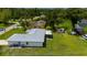 A peaceful backyard view features a well-maintained lawn, a screen porch, and ample space for outdoor enjoyment at 1865 Rival Ter, North Port, FL 34286