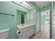 Bathroom featuring a single sink vanity and a view to the living room and window at 1865 Rival Ter, North Port, FL 34286