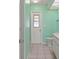 Compact bathroom with a toilet, vanity, and natural light streaming in from a glass window at 1865 Rival Ter, North Port, FL 34286