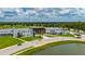 Exterior view of the modern building showcasing its architecture, landscaping, and a tranquil pond at 1865 Rival Ter, North Port, FL 34286