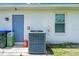 Exterior of a home with an air conditioner, utility connection, and a window at 1865 Rival Ter, North Port, FL 34286