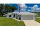 Attractive property boasts a wide driveway, lush lawn, and charming facade at 1865 Rival Ter, North Port, FL 34286