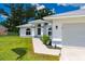 This angle highlights the front entrance and the attached two-car garage on this single-story home at 1865 Rival Ter, North Port, FL 34286