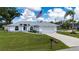 Charming home with an attached garage, pristine landscaping, and a welcoming front yard with mature trees at 1865 Rival Ter, North Port, FL 34286
