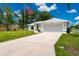 Inviting home features a double-car garage, well-maintained lawn, and classic architectural design at 1865 Rival Ter, North Port, FL 34286