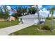 A charming single-story home featuring a well-manicured lawn, a two-car garage, and an American flag at 1865 Rival Ter, North Port, FL 34286