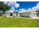 Charming single-story home featuring a well-manicured lawn and an attached two-car garage at 1865 Rival Ter, North Port, FL 34286