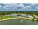 Aerial view of the building showcasing modern architecture, green spaces, and a tranquil pond with a fountain at 1865 Rival Ter, North Port, FL 34286