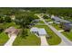 Classic home boasts a lush green lawn, mature trees, and a welcoming entrance in a quiet neighborhood at 1865 Rival Ter, North Port, FL 34286