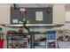 Image shows HVAC system mounted in a garage with storage shelves below it; 8kW unit at 1865 Rival Ter, North Port, FL 34286