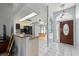 Open concept kitchen flowing into the front entry, dinette, and equipped with modern appliances at 1865 Rival Ter, North Port, FL 34286