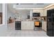 Kitchen featuring white cabinets, black appliances, and granite countertops at 1865 Rival Ter, North Port, FL 34286
