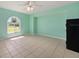 Light and airy living room with a large window and neutral tile flooring at 1865 Rival Ter, North Port, FL 34286