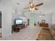 Bright living room featuring tile floors, ceiling fans, and ample space at 1865 Rival Ter, North Port, FL 34286
