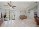 Bright living area with sliding glass doors leading to the backyard, neutral palette and tile flooring at 1865 Rival Ter, North Port, FL 34286