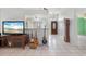 Inviting living area featuring tile floors, an entertainment center, and natural light at 1865 Rival Ter, North Port, FL 34286
