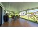 Enjoy outdoor dining in this spacious covered patio with tile flooring and screen surround at 1865 Rival Ter, North Port, FL 34286