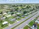 Neighborhood aerial featuring cozy homes, tree-lined streets, and a tranquil lake view at 22341 Midway Blvd, Port Charlotte, FL 33952
