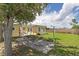 Spacious backyard with well-maintained lawn, patio area, and mature tree at 22341 Midway Blvd, Port Charlotte, FL 33952