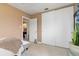 Peach colored bedroom with white double door closet and view into the bathroom at 22341 Midway Blvd, Port Charlotte, FL 33952