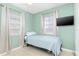 Neutral toned bedroom with a single bed, curtains and mounted tv at 22341 Midway Blvd, Port Charlotte, FL 33952