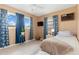 Bright bedroom with a single bed, blue curtains, and a view of the outdoors at 22341 Midway Blvd, Port Charlotte, FL 33952