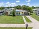 Inviting one-story house with lovely landscaping and a well-manicured lawn at 22341 Midway Blvd, Port Charlotte, FL 33952