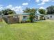 Charming single-story home boasts a lush front lawn and inviting curb appeal at 22341 Midway Blvd, Port Charlotte, FL 33952