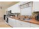 Bright kitchen with white cabinetry, stainless steel appliances, and a decorative window treatment at 22341 Midway Blvd, Port Charlotte, FL 33952