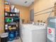 Functional laundry room with washer, dryer, shelving, and ample storage space at 22341 Midway Blvd, Port Charlotte, FL 33952