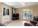 Spacious living room with sliding glass doors leading to an outdoor area and adjacent kitchen at 22341 Midway Blvd, Port Charlotte, FL 33952