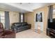 Comfortable living room with a leather sofa, neutral walls, and tile floors at 22341 Midway Blvd, Port Charlotte, FL 33952