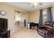 Versatile living room with desk and sliding glass door providing natural light and access to other rooms at 22341 Midway Blvd, Port Charlotte, FL 33952
