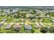 Aerial view of a neighborhood with mature trees, a lake, and a pin highlighting the house location at 25062 Palisade Rd, Punta Gorda, FL 33983