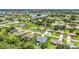 Expansive neighborhood view showcasing a blend of residential homes and natural scenery with a pond at 25062 Palisade Rd, Punta Gorda, FL 33983