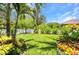 Lush green backyard with a white fence offers privacy and a serene space, perfect for relaxing and enjoying the outdoors at 25062 Palisade Rd, Punta Gorda, FL 33983