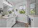 Bright bathroom featuring a vanity with marble countertops, a glass enclosed shower, and wood look flooring at 25062 Palisade Rd, Punta Gorda, FL 33983