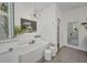 Bright bathroom featuring a soaking tub, chandelier, and wood look flooring at 25062 Palisade Rd, Punta Gorda, FL 33983