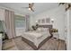 Bedroom featuring a neutral color scheme, ceiling fan, and soft natural light at 25062 Palisade Rd, Punta Gorda, FL 33983
