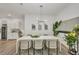 Bright dining area with modern chandelier, stylish décor, and adjacent kitchen cabinets and appliances at 25062 Palisade Rd, Punta Gorda, FL 33983