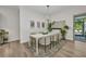 Bright dining room featuring a modern chandelier, stylish decor, and sliding glass doors to the lanai at 25062 Palisade Rd, Punta Gorda, FL 33983
