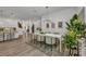 Open dining space showcases modern lighting, stylish décor, and transitions seamlessly to the kitchen and living spaces at 25062 Palisade Rd, Punta Gorda, FL 33983